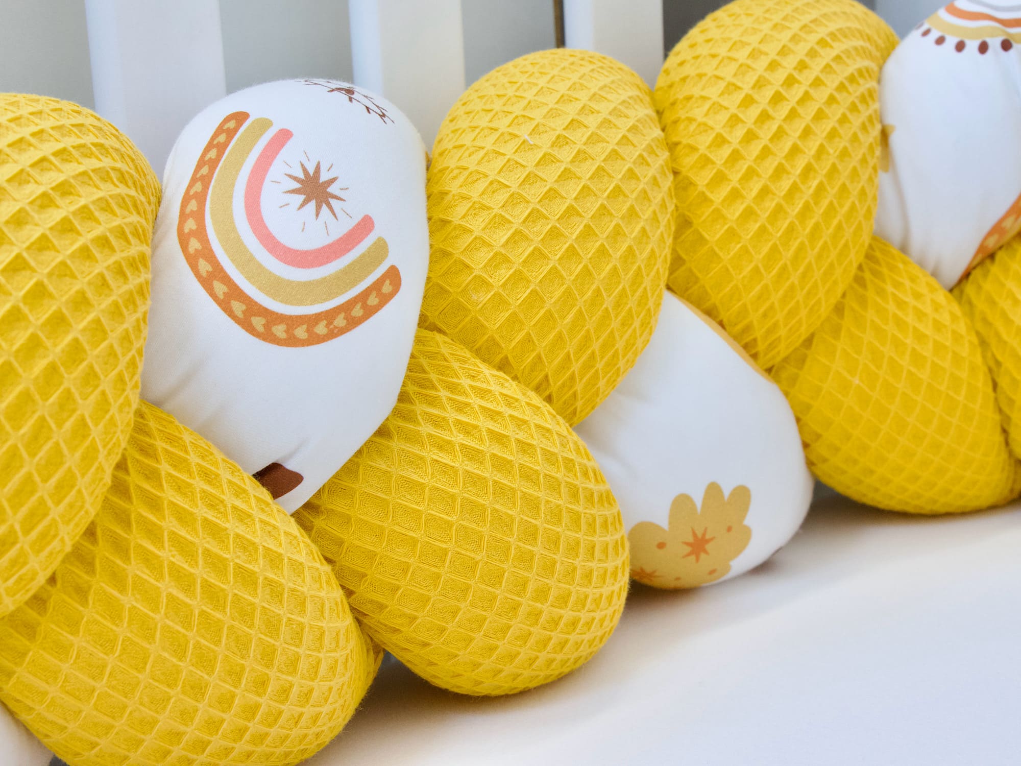 Detailaufnahme Bettschlange Waffelpique Gelb mit Regenbogenmotiv – weich & hochwertig
