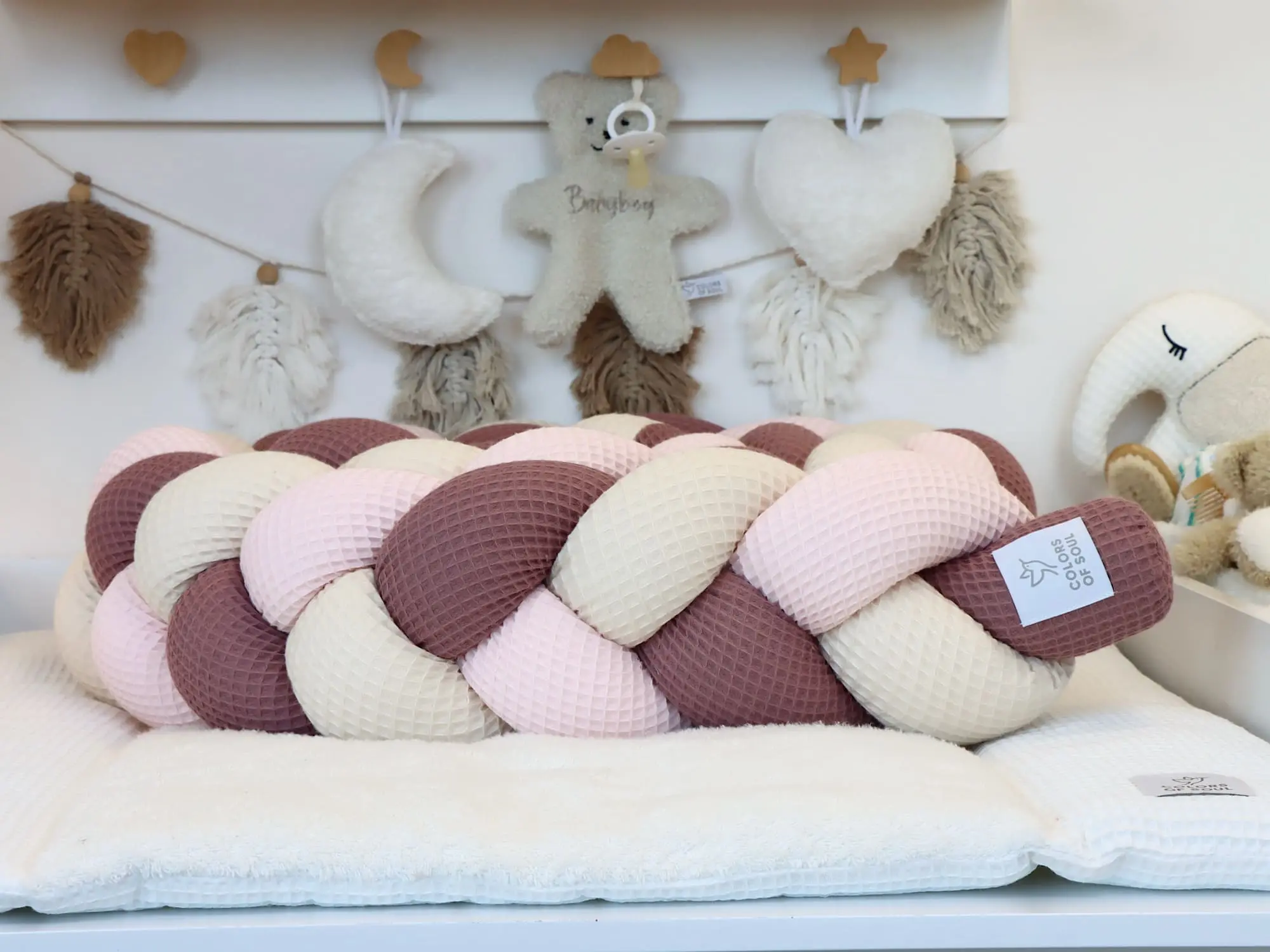 Bettschlange geflochten aus Waffelpique in Alte Malve, Hellrosa und Hellbeige im hellen Babyzimmer